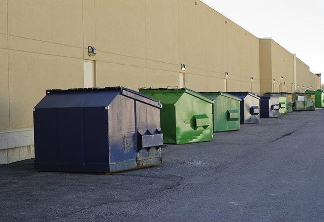 a row of yellow and blue dumpsters at a construction site in Coxs Creek KY